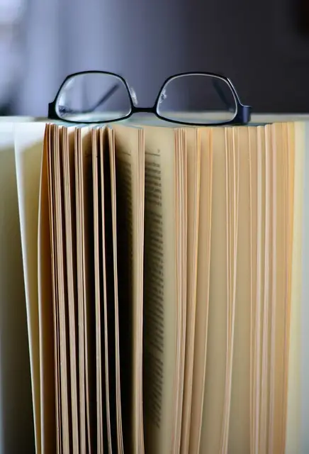 body_book_pages_glasses.webp